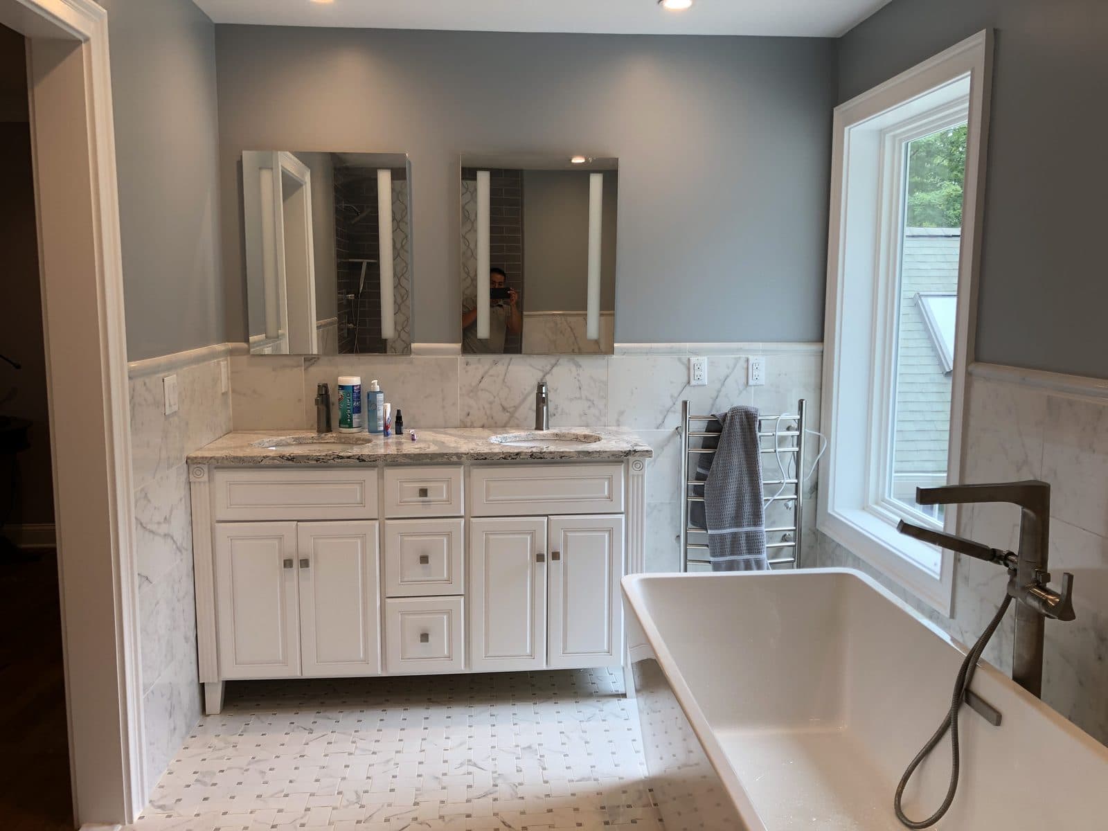 Renovated bathroom with double vanity and tub