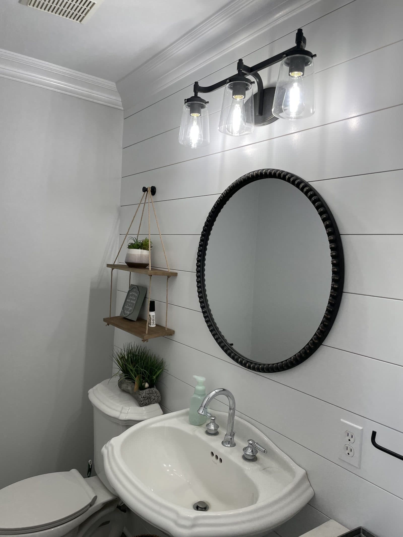 Modern bathroom with round mirror vanity