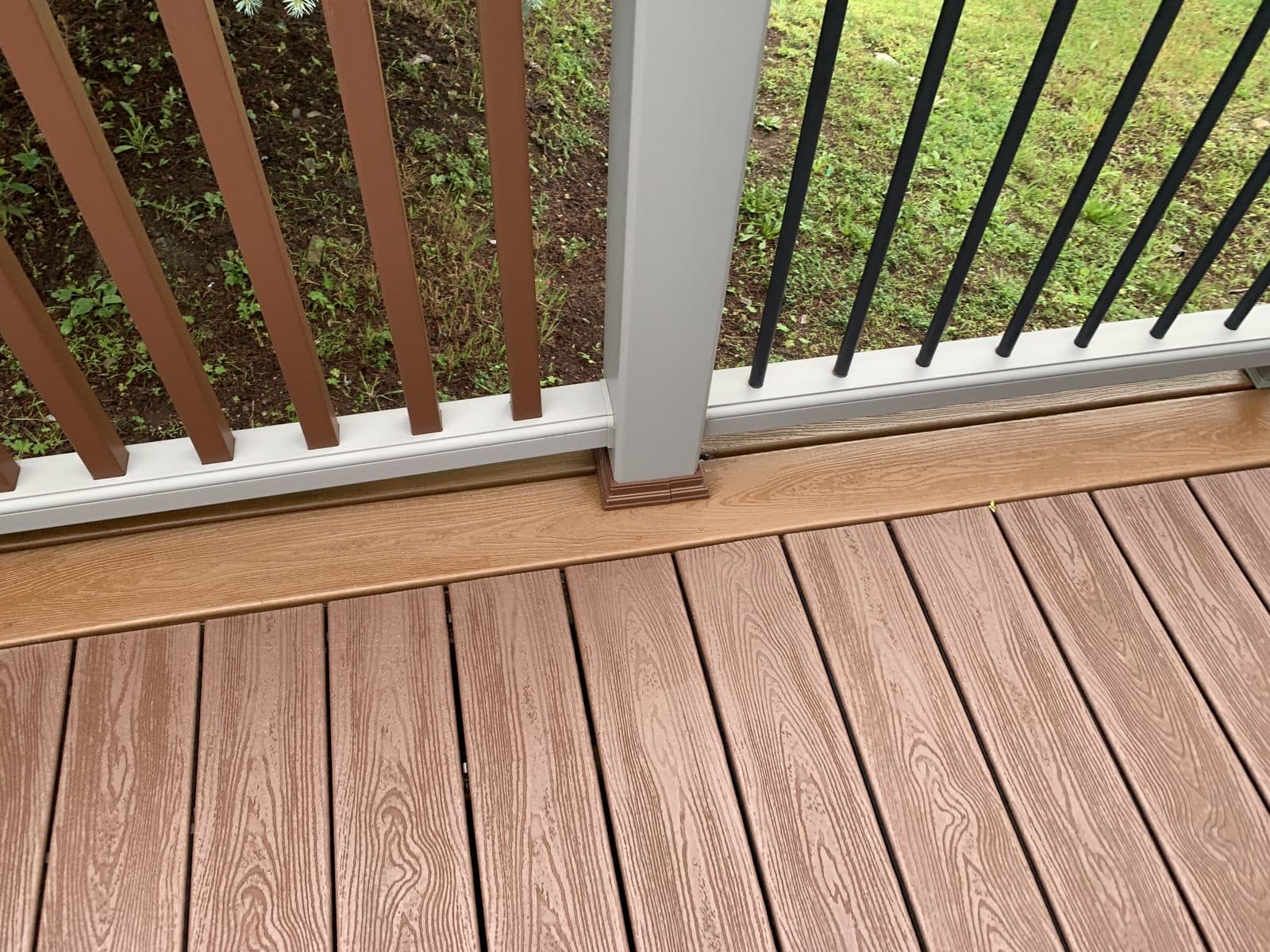 Stained wood deck with green lawn