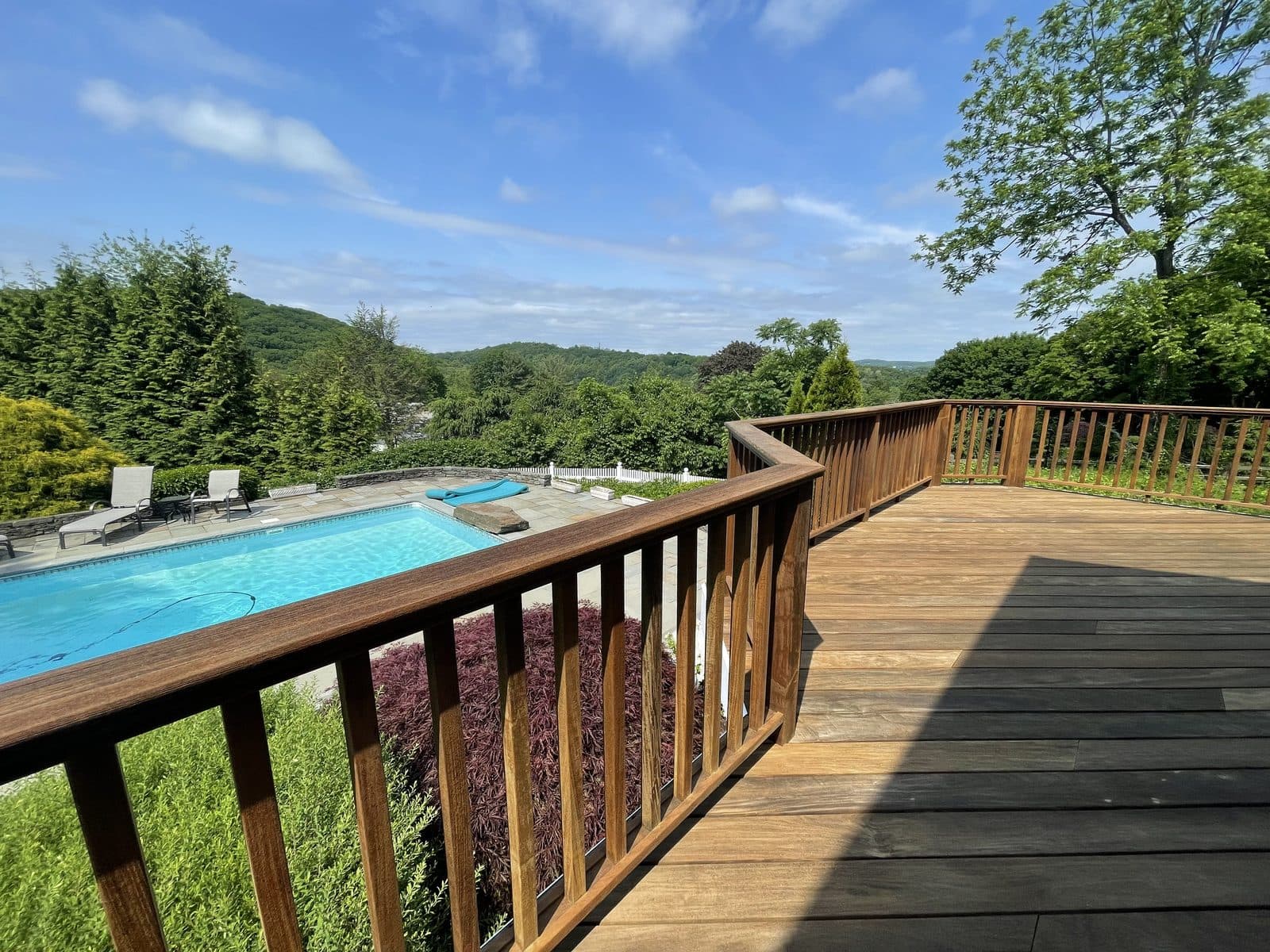 Wood railing deck with pool view