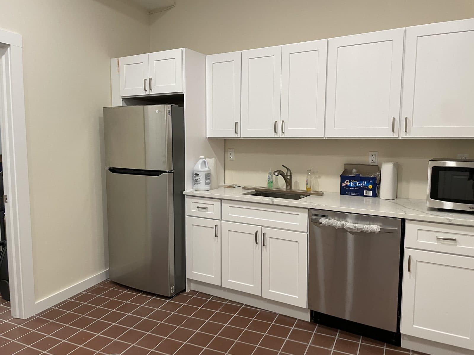White kitchen with stainless appliances