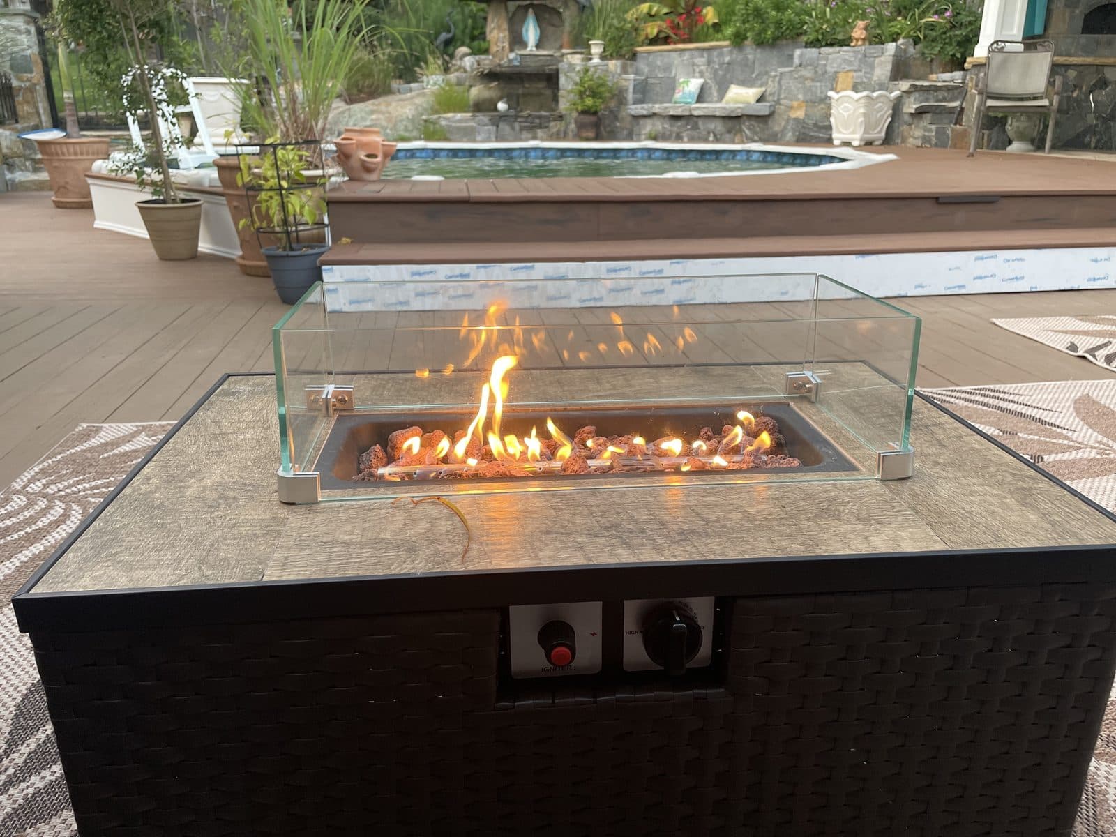 Outdoor fire pit table on stone patio