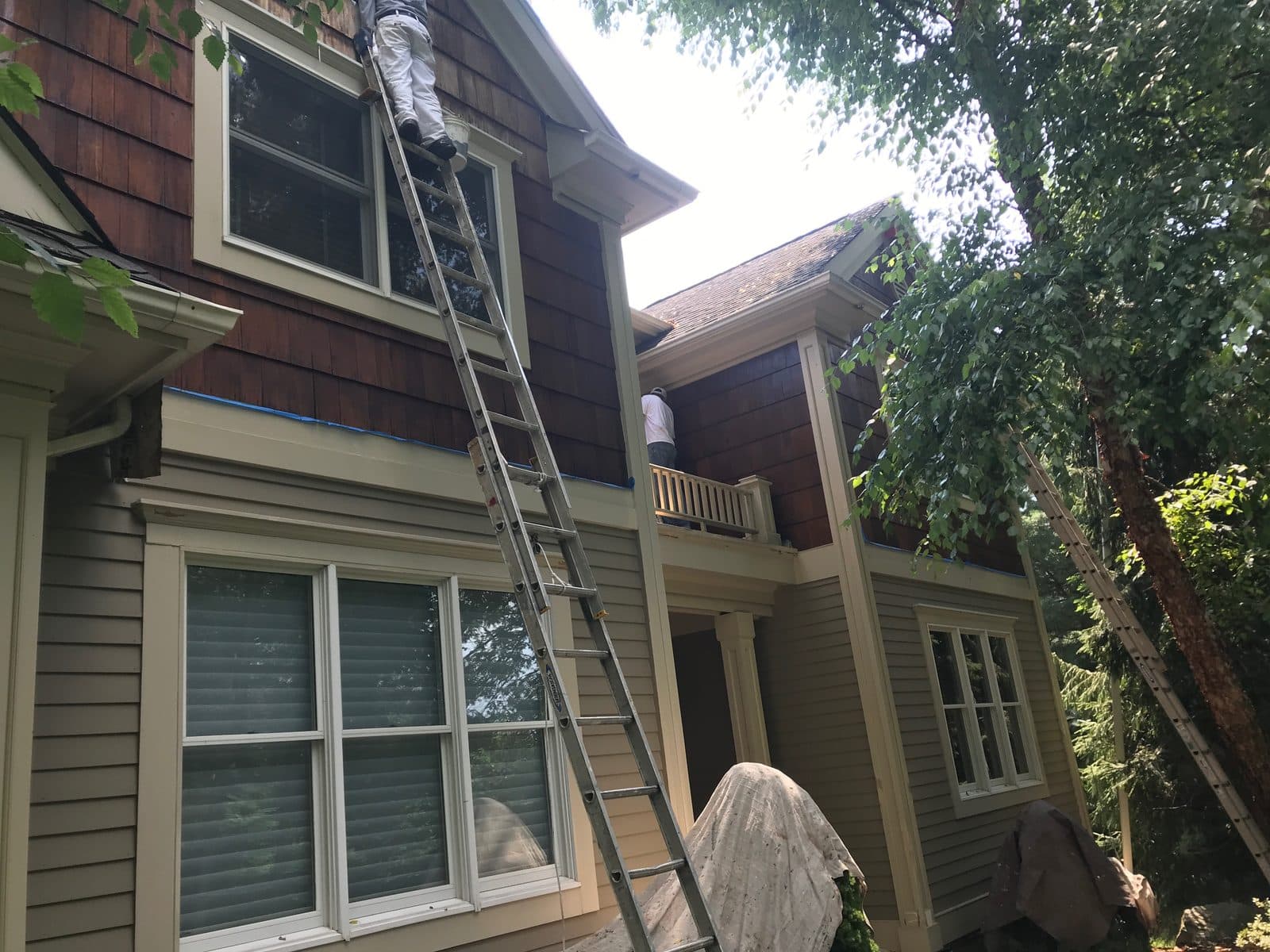 Crew washing and prepping a cedar-sided home exterior