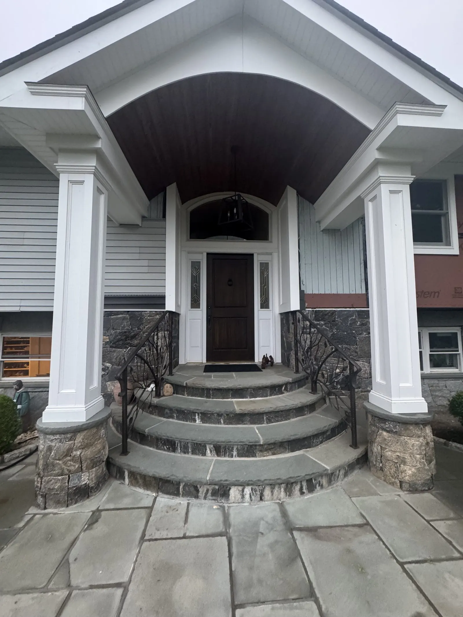 Siding installation with a new columned portico in Mahopac, NY