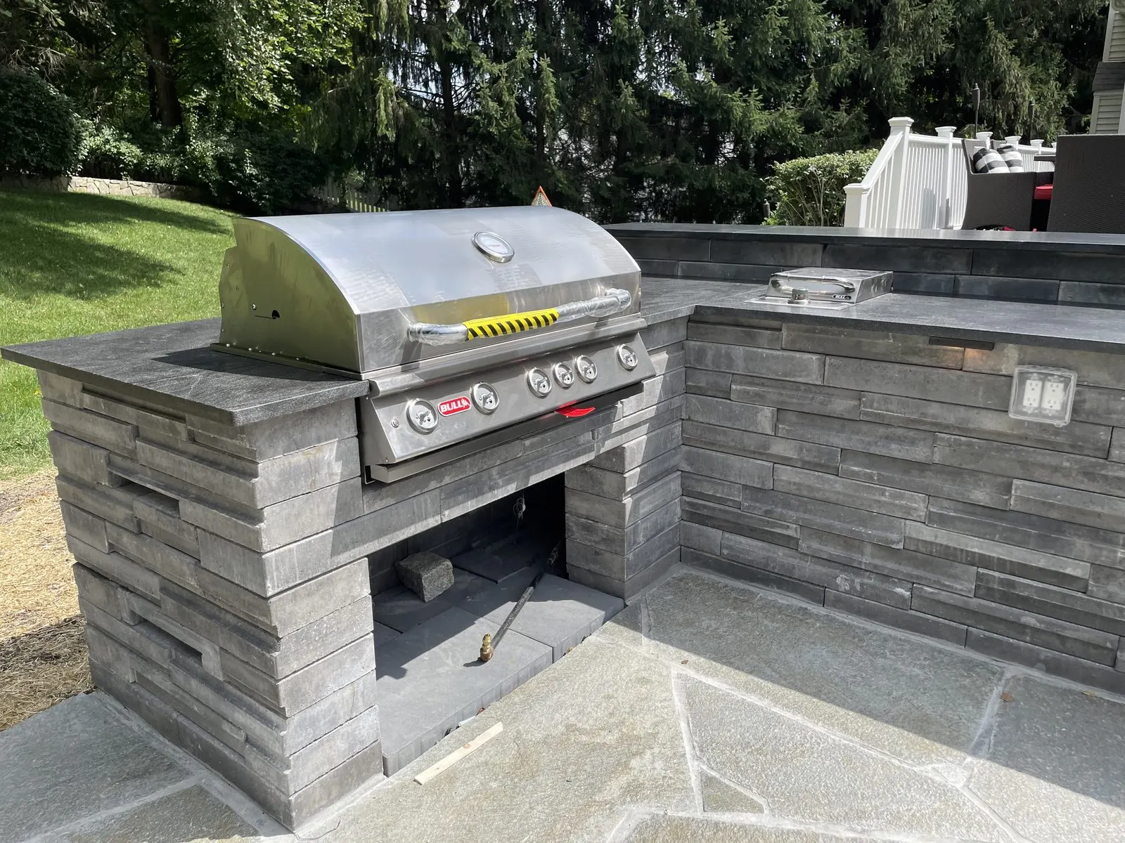 Stone outdoor kitchen grill station