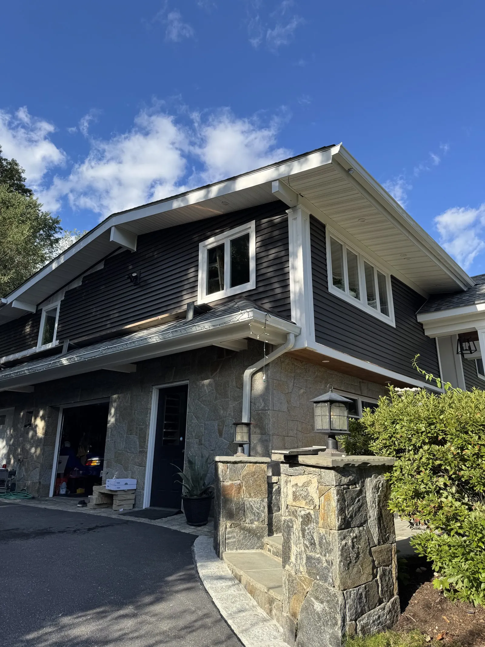 Siding installation with stone pillars and trim in Somers, NY