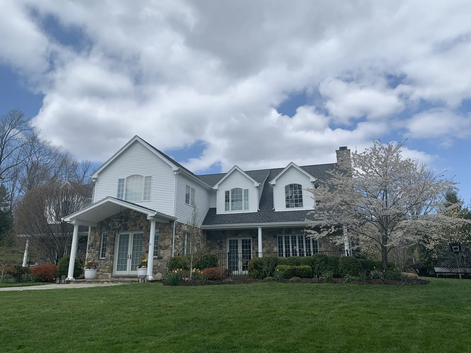 Exterior house painting on a dormered colonial in Westchester County, NY