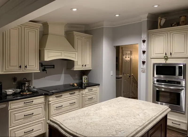 Cream kitchen remodel with custom island and range hood