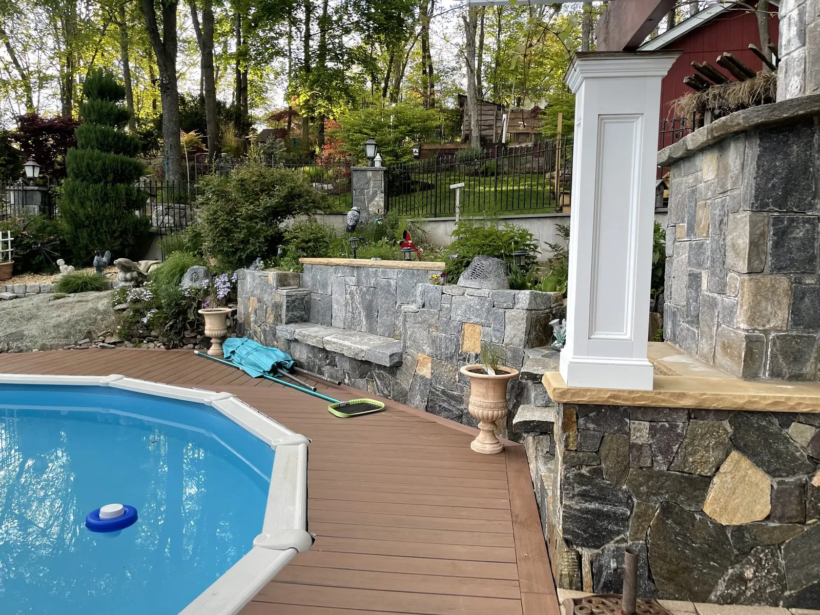 Pool with stone patio and house