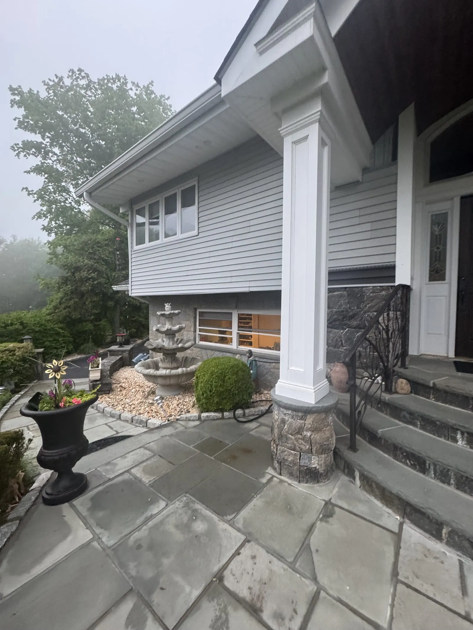 Siding installation with a bluestone patio in Westchester County, NY