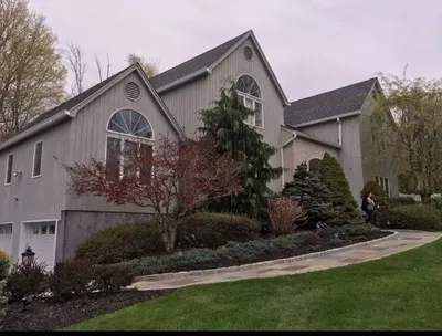 Exterior repaint on a home with peaked rooflines in Carmel, NY