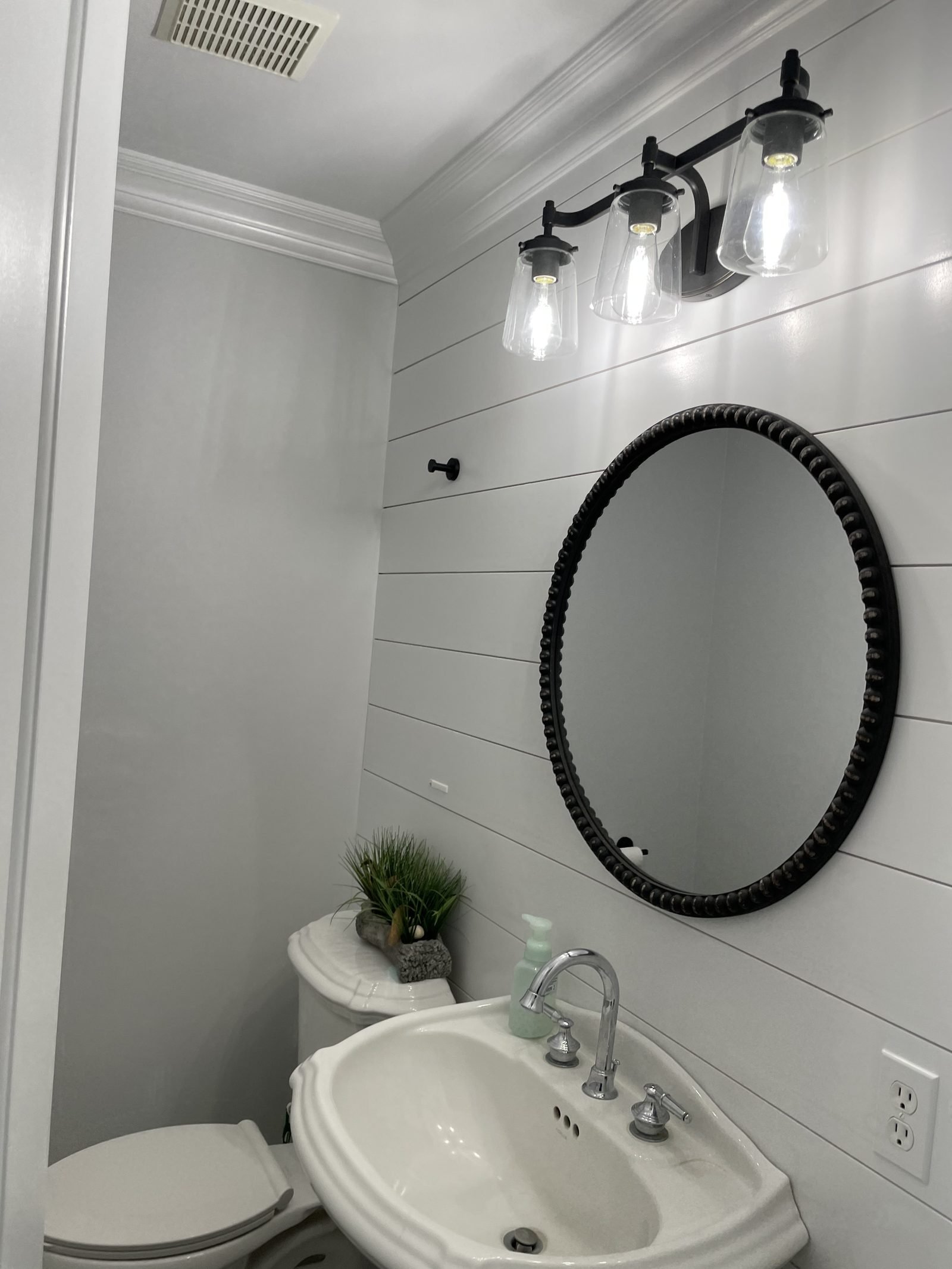 White bathroom with round mirror vanity