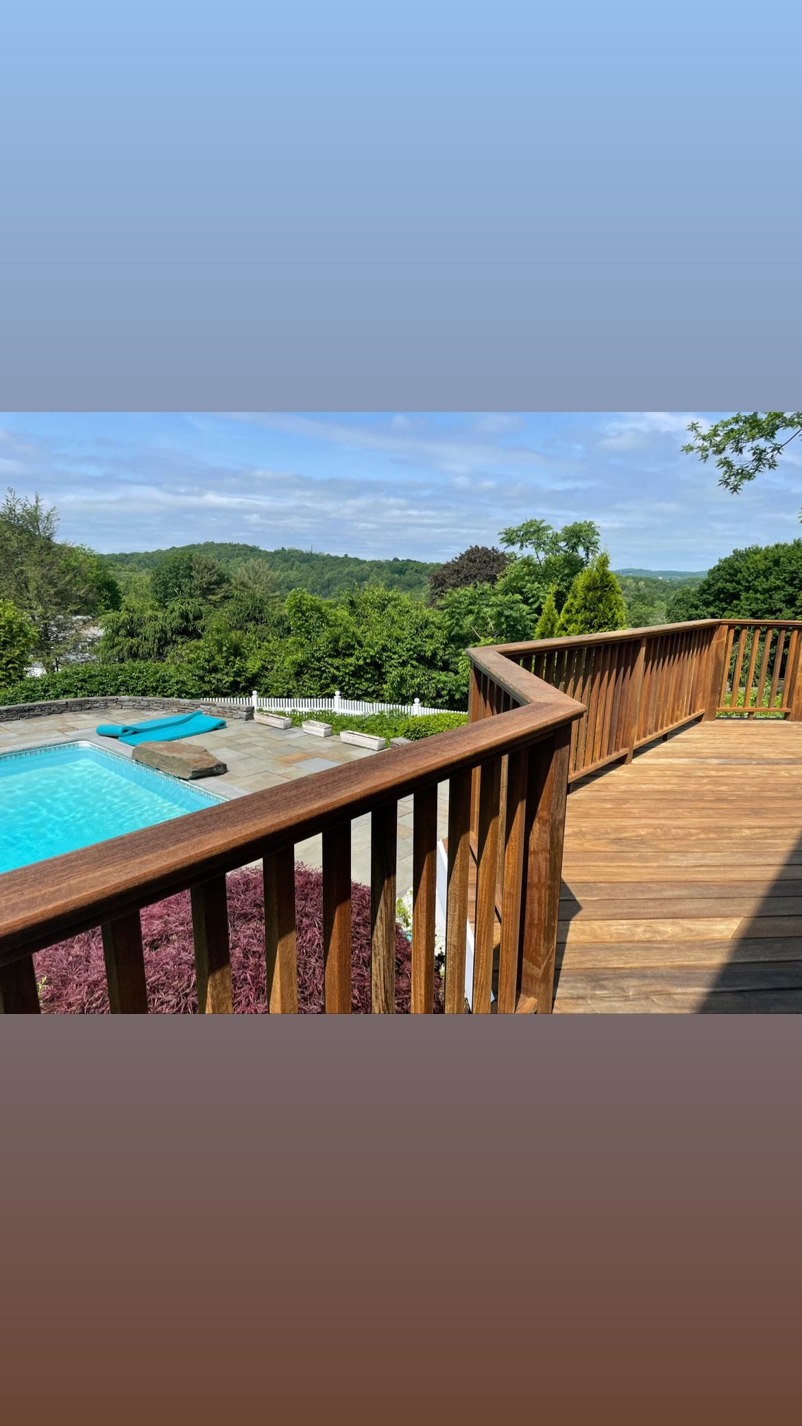 Wood deck overlooking pool and trees