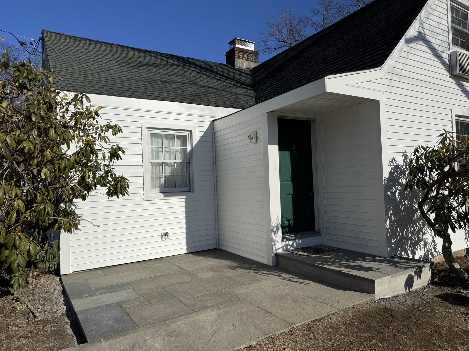 White house exterior with landscaping