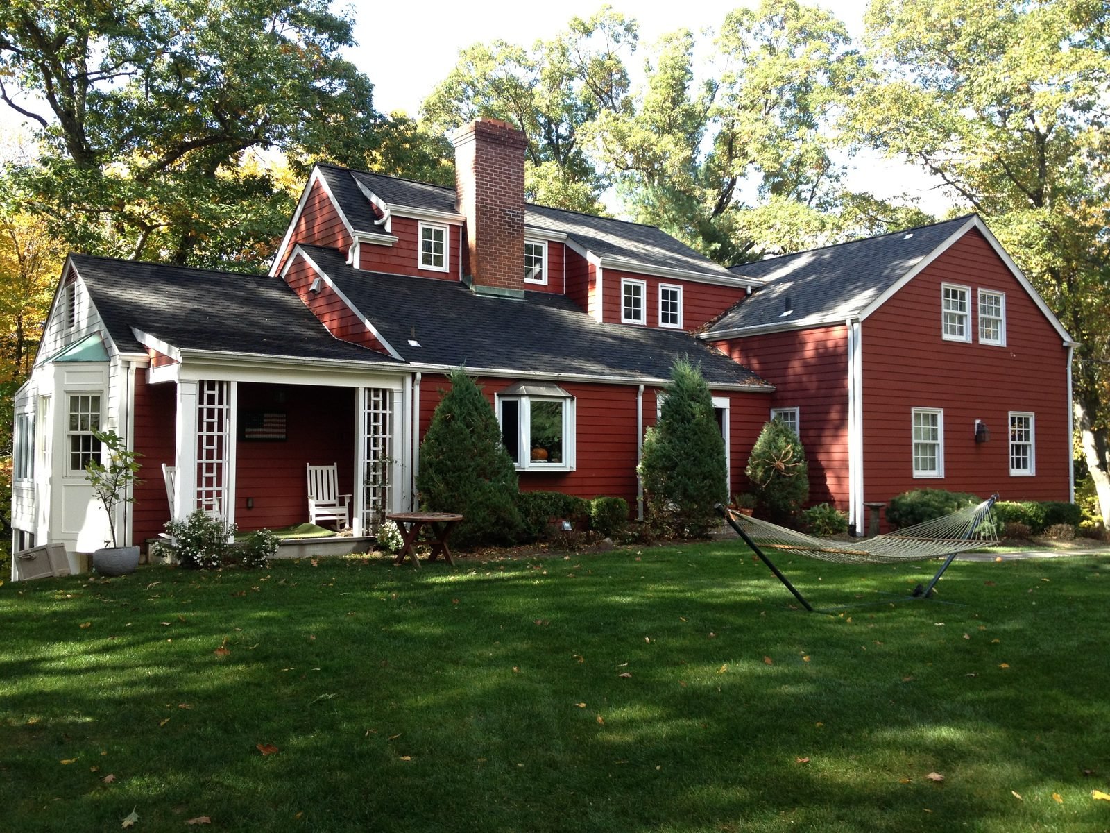 Red colonial home with white trim