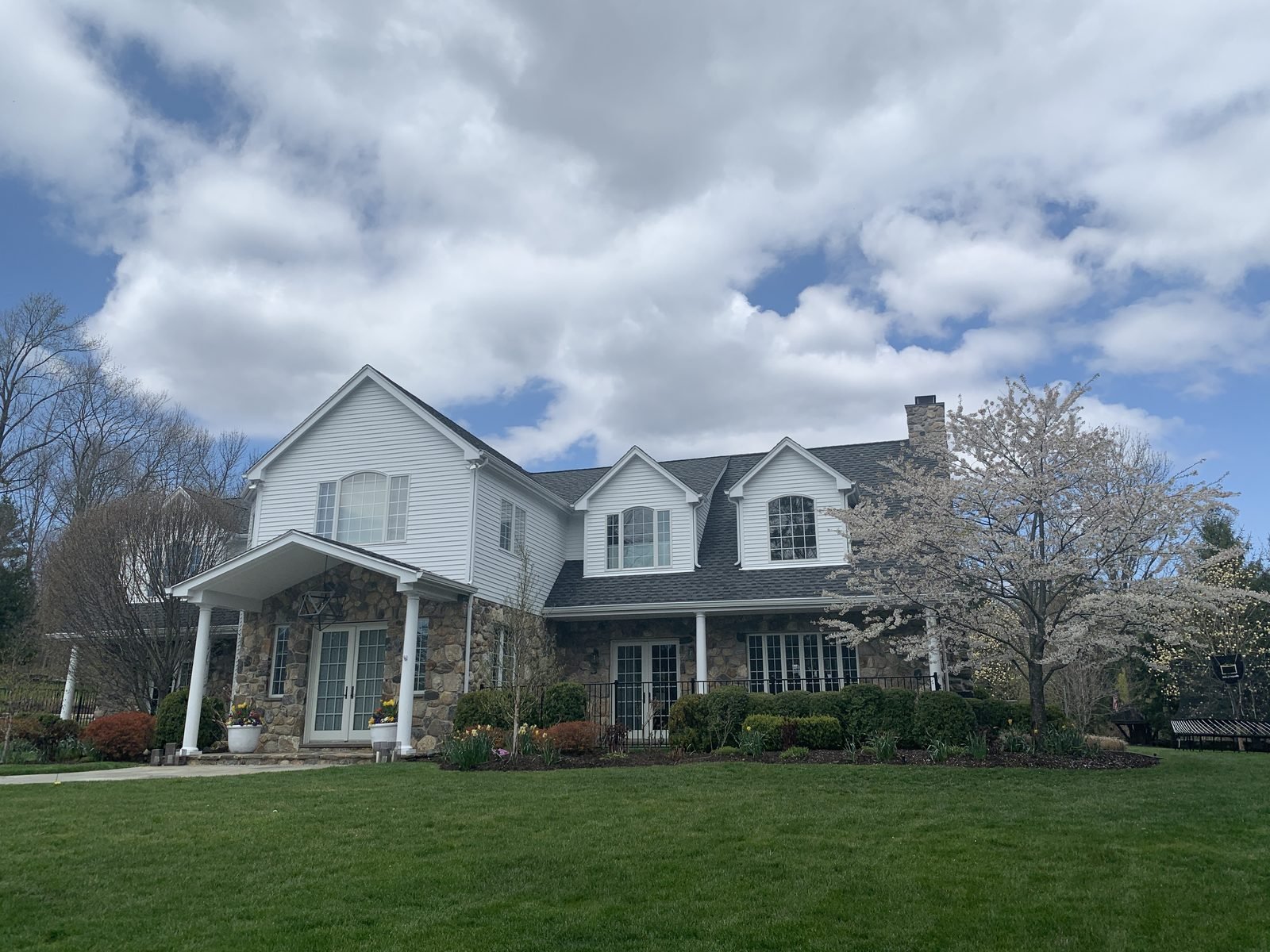White colonial home with dormers