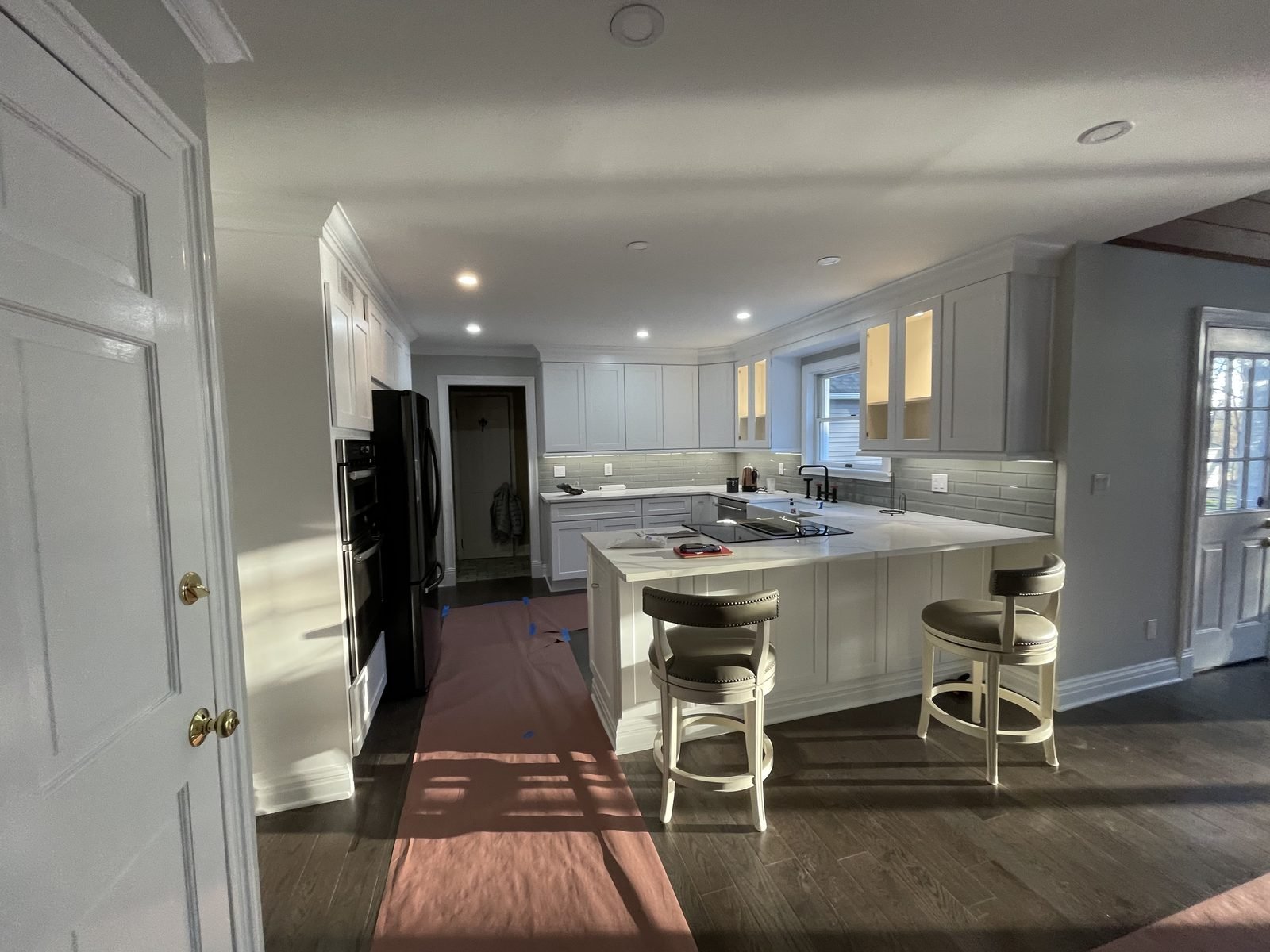 White kitchen island with pendant lights