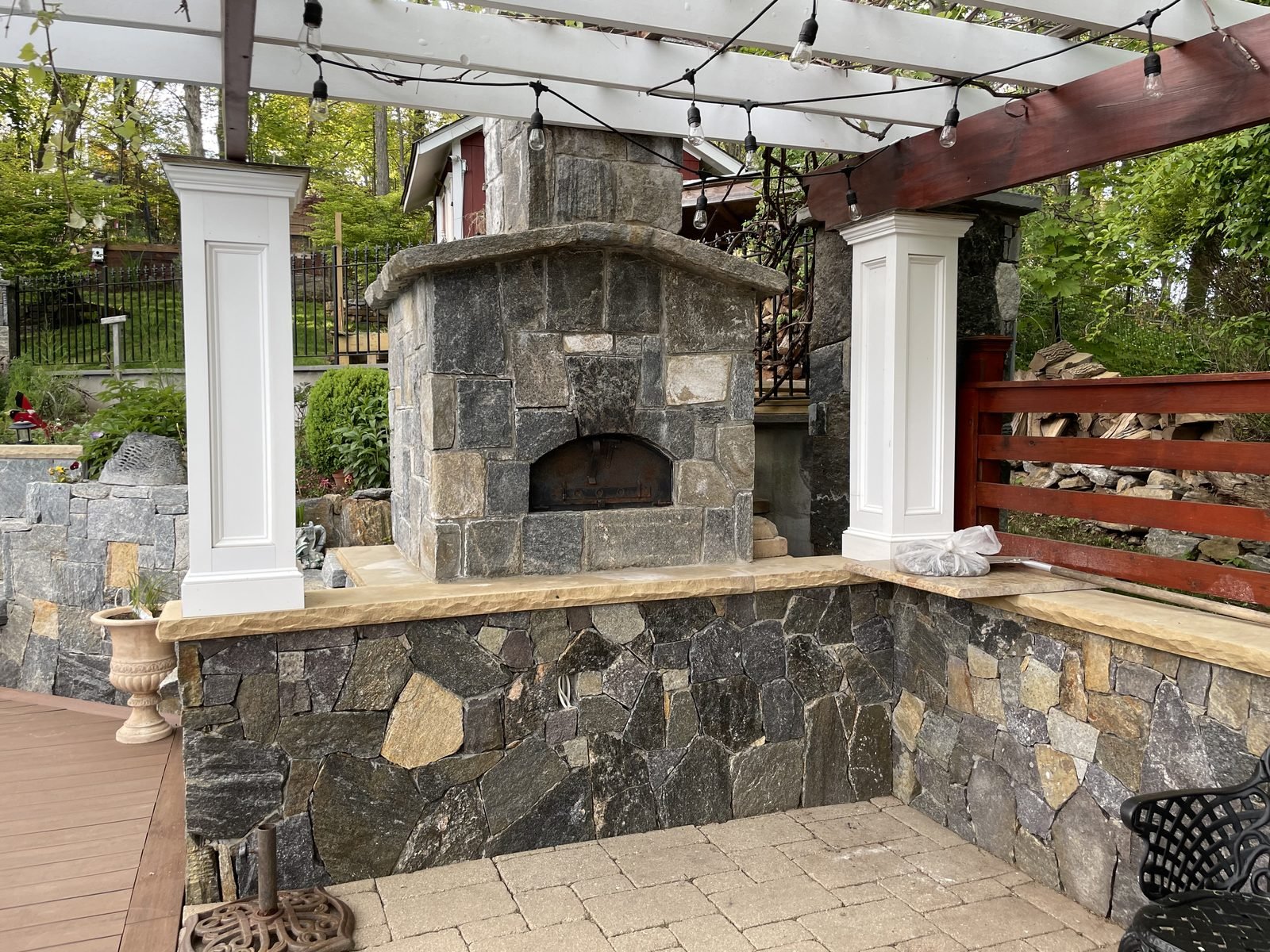 Stone outdoor fireplace and pergola masonry project