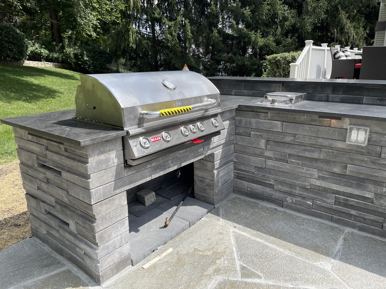 Stone outdoor kitchen grill station